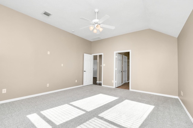 interior space with ceiling fan, light carpet, and vaulted ceiling