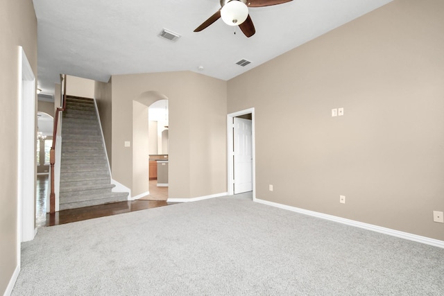 unfurnished living room featuring ceiling fan, carpet floors, and vaulted ceiling