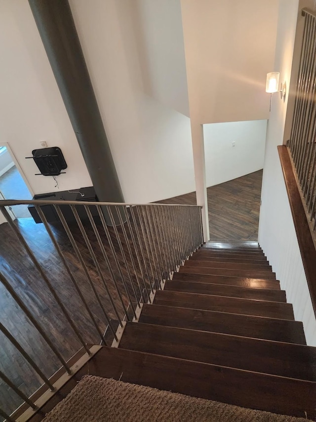 stairway featuring wood-type flooring