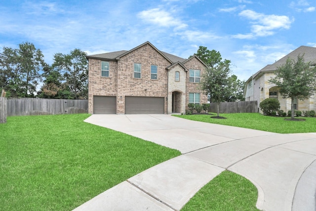 view of front of house with a garage and a front lawn