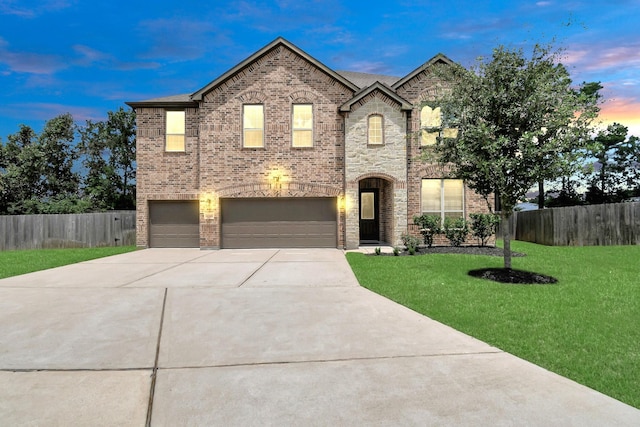 view of front of home featuring a garage and a lawn