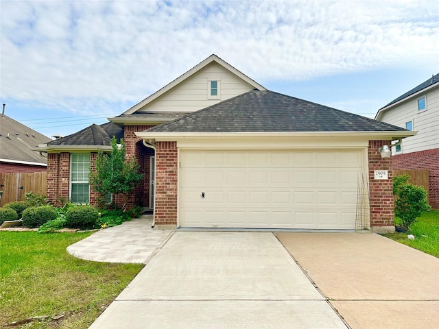 view of front of property with a garage and a front yard