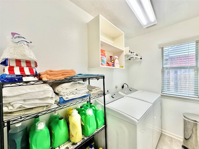 washroom featuring light tile patterned floors and washing machine and clothes dryer