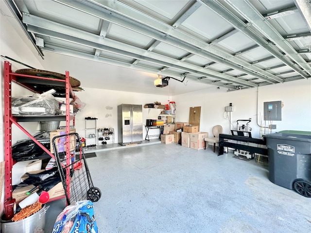 garage with stainless steel fridge with ice dispenser, electric panel, and a garage door opener