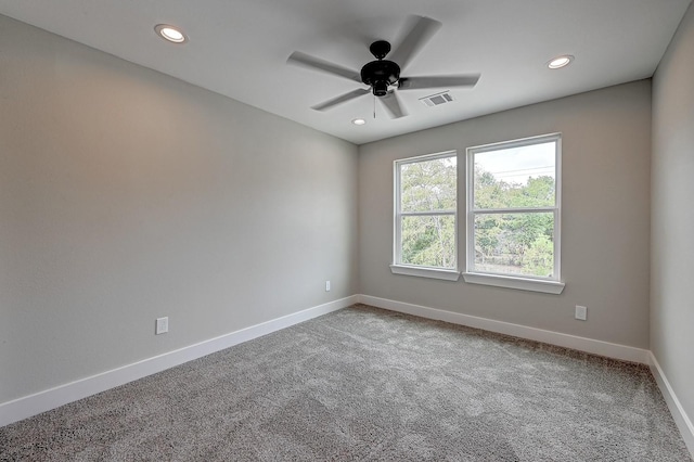 spare room featuring ceiling fan and carpet