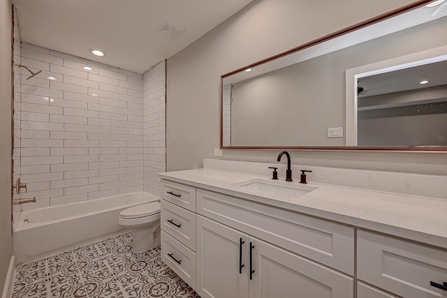 full bathroom with tile patterned flooring, vanity, toilet, and tiled shower / bath