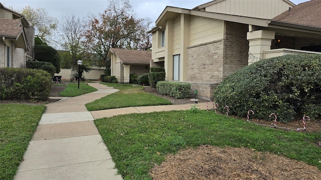 view of side of home with a yard