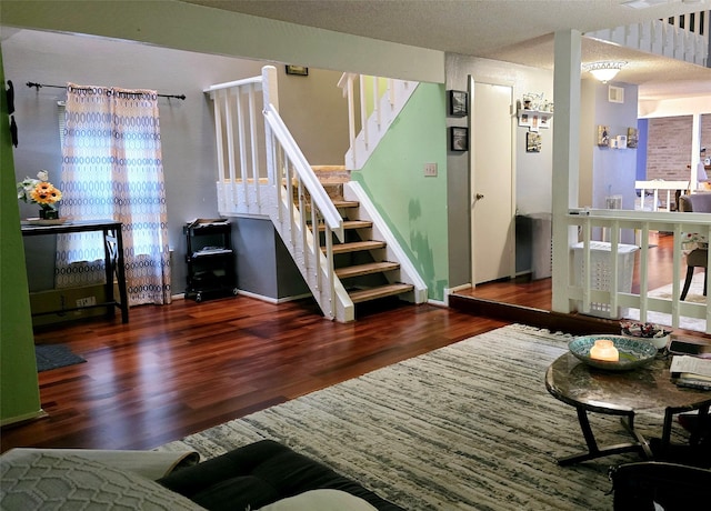 interior space with dark hardwood / wood-style floors and a textured ceiling