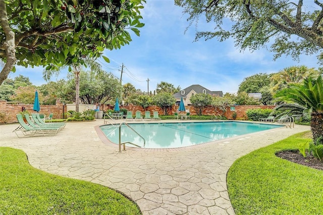 view of swimming pool with a patio and a lawn