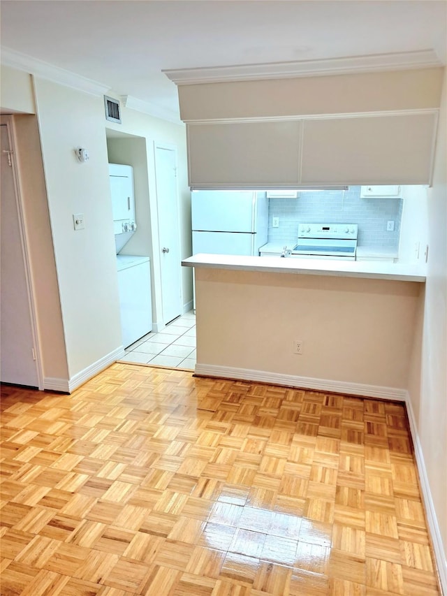 kitchen featuring white refrigerator, backsplash, stacked washer and dryer, electric stove, and ornamental molding