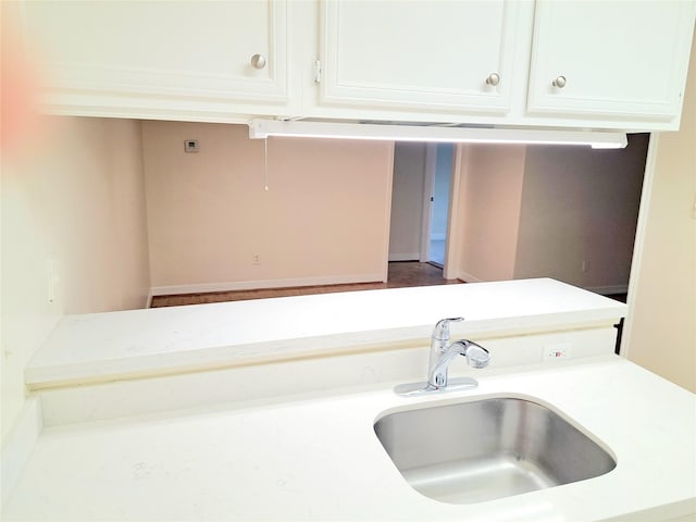 kitchen with white cabinetry and sink