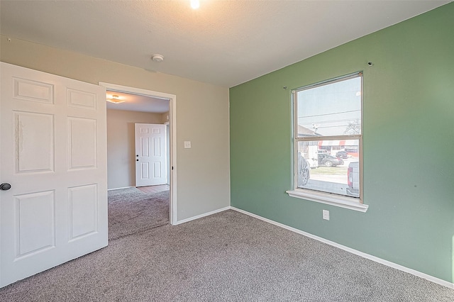 unfurnished room featuring carpet