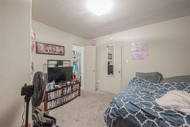 bedroom featuring light carpet and a textured ceiling