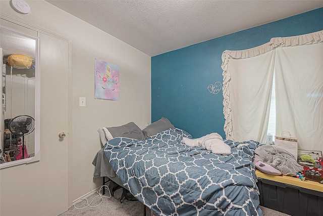 bedroom with carpet and a textured ceiling