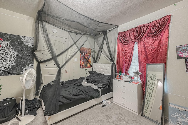 bedroom with carpet floors and a textured ceiling