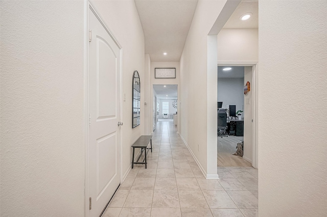 hall featuring light tile patterned floors