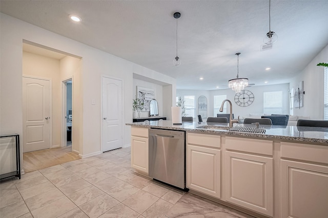 kitchen with an inviting chandelier, sink, hanging light fixtures, stainless steel dishwasher, and light stone counters