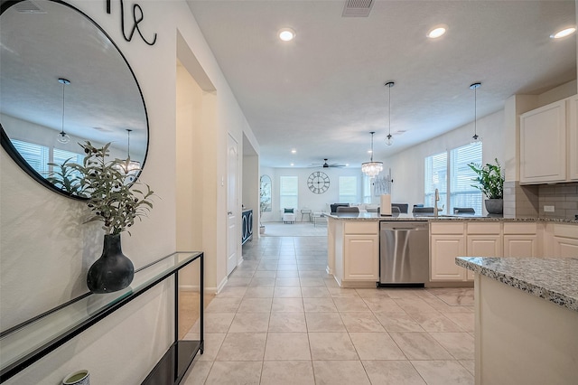 kitchen featuring ceiling fan, tasteful backsplash, stainless steel dishwasher, decorative light fixtures, and white cabinets