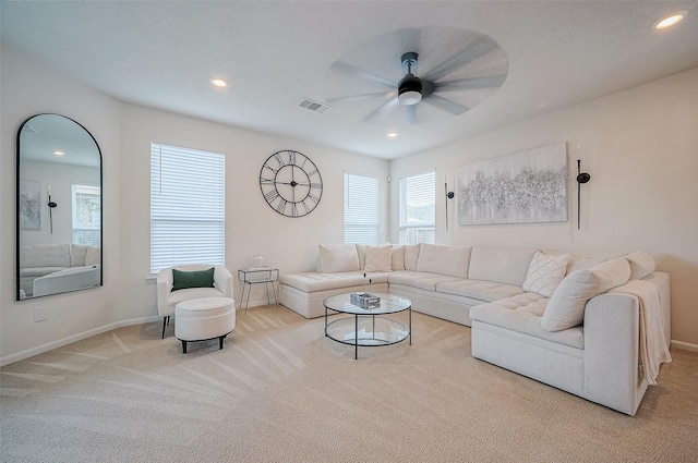 carpeted living room with ceiling fan