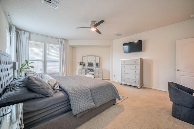 bedroom with ceiling fan and light carpet