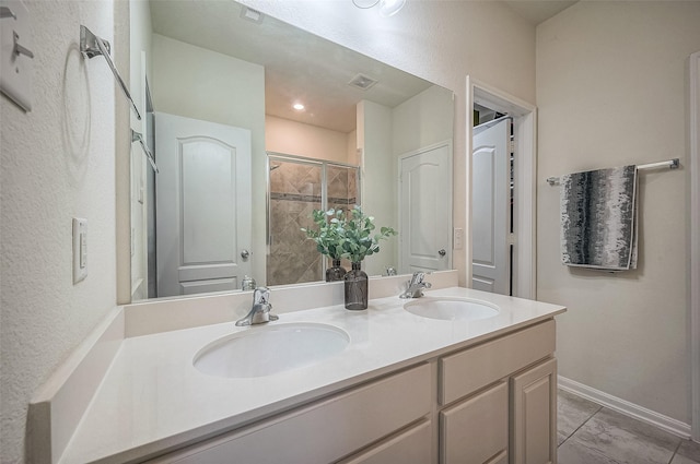 bathroom with vanity, tile patterned floors, and a shower with shower door