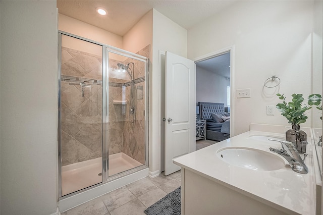 bathroom with tile patterned flooring, vanity, and a shower with door