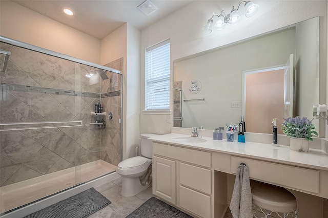 bathroom with toilet, a shower with door, vanity, and tile patterned flooring