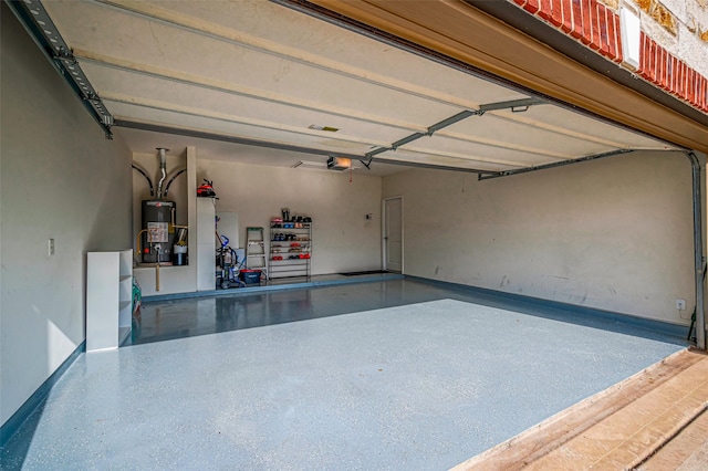 garage featuring water heater and a garage door opener