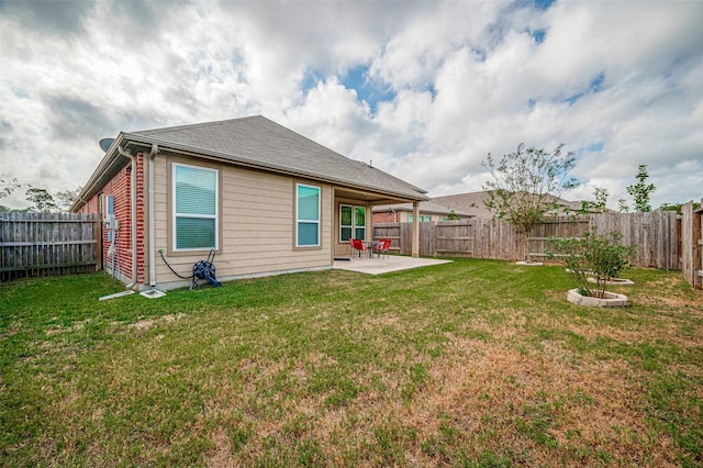 back of property with a yard and a patio