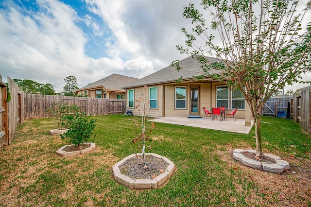 rear view of property with a lawn and a patio area