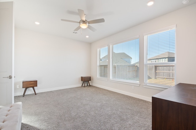 sitting room featuring ceiling fan and carpet