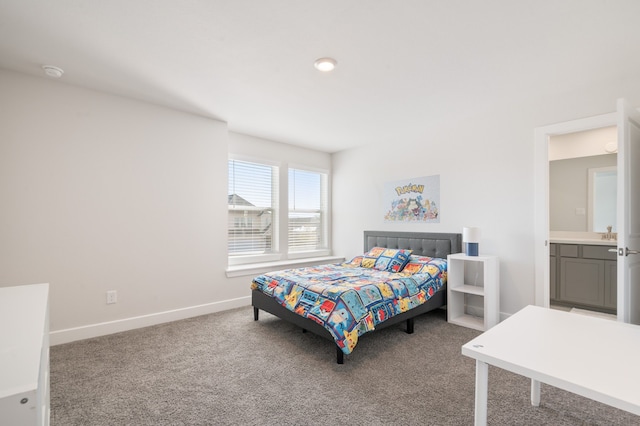 carpeted bedroom featuring ensuite bath