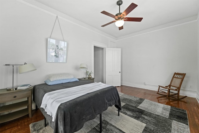 bedroom featuring ceiling fan, dark wood-type flooring, and ornamental molding