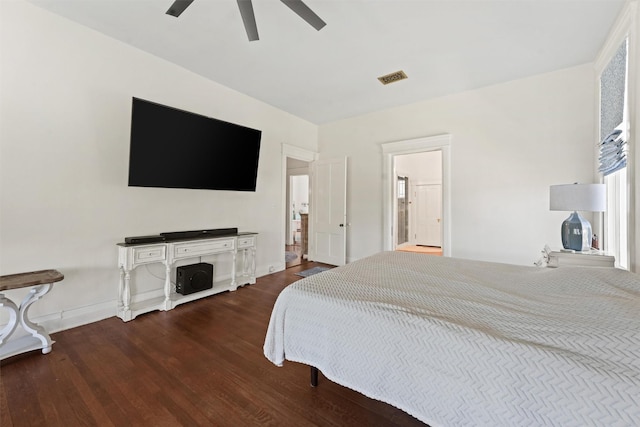 bedroom with hardwood / wood-style floors, ceiling fan, and ensuite bathroom