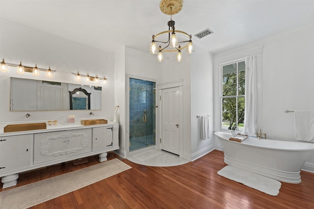 bathroom with vanity, wood-type flooring, plus walk in shower, and a chandelier