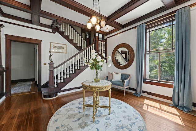 interior space featuring hardwood / wood-style flooring, crown molding, a healthy amount of sunlight, and coffered ceiling