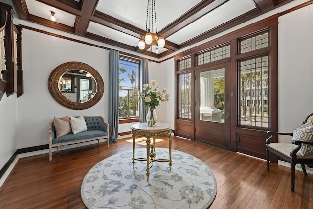 interior space featuring dark hardwood / wood-style flooring, ornamental molding, coffered ceiling, beam ceiling, and a notable chandelier