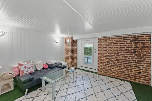 unfurnished living room with wood walls and brick wall