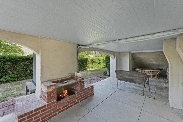 view of patio with an outdoor brick fireplace