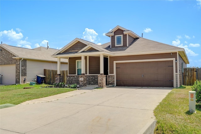 view of front of house with a front lawn, covered porch, and a garage