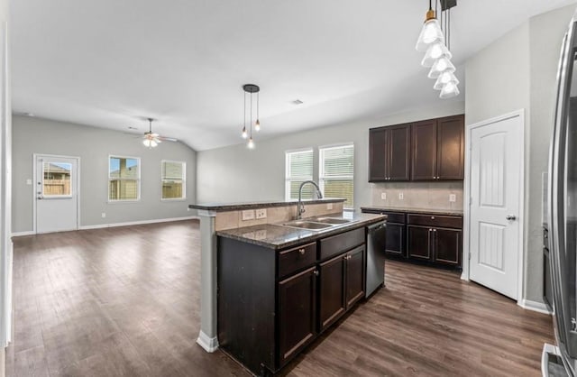 kitchen with backsplash, decorative light fixtures, stainless steel dishwasher, and sink