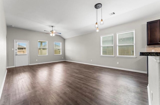 unfurnished living room featuring ceiling fan, dark wood-type flooring, and vaulted ceiling