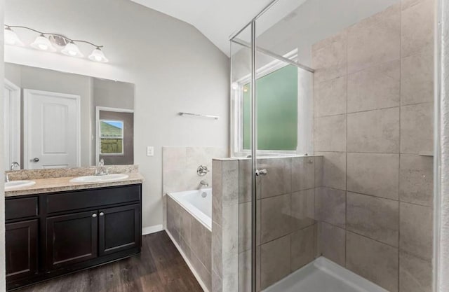 bathroom with vanity, plus walk in shower, lofted ceiling, and hardwood / wood-style flooring