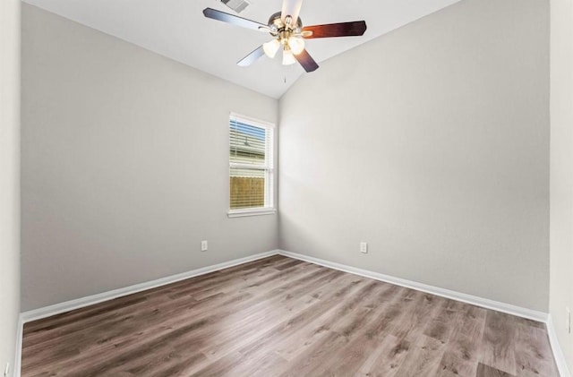 unfurnished room featuring ceiling fan, wood-type flooring, and vaulted ceiling