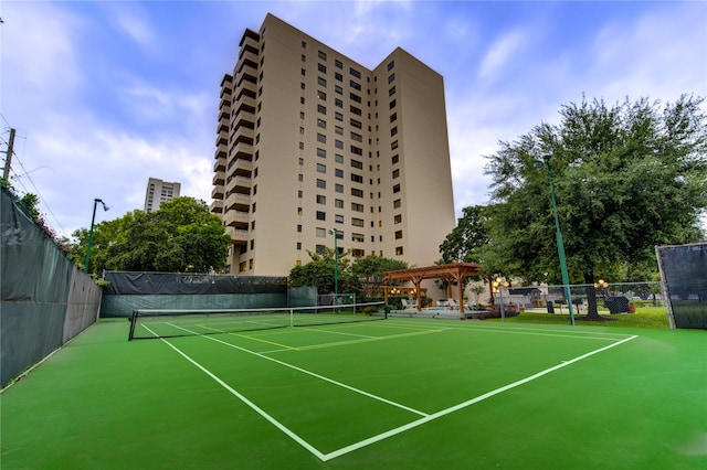 view of tennis court with a pergola