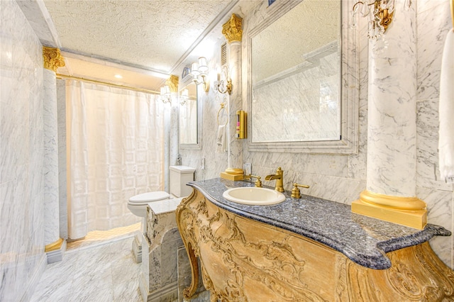 bathroom featuring vanity, a textured ceiling, and ornamental molding