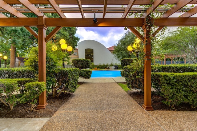 view of swimming pool with a pergola and a patio