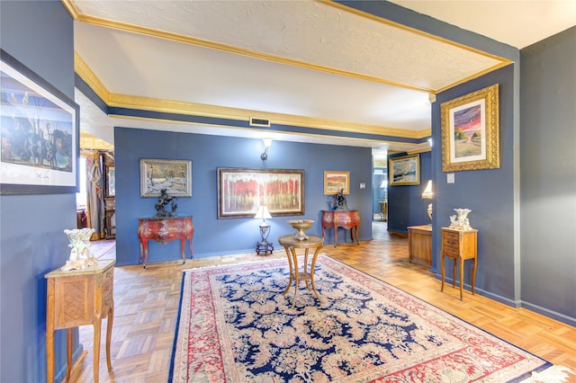 sitting room with a textured ceiling, crown molding, and light parquet floors