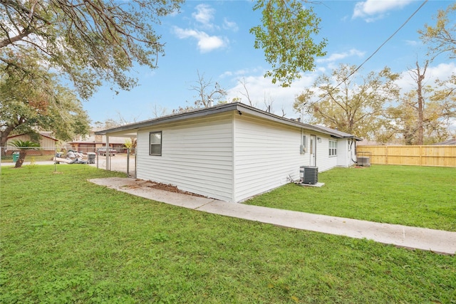 view of side of property featuring a yard and central AC unit