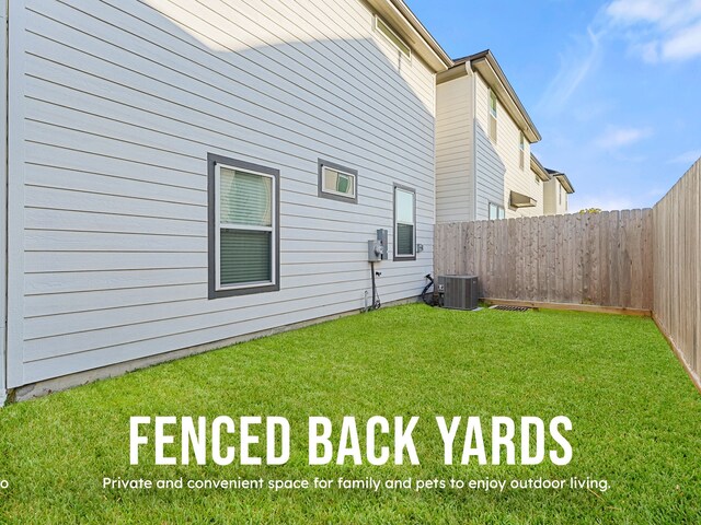 rear view of property featuring a yard and central air condition unit